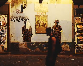 Group of people against graffiti on wall