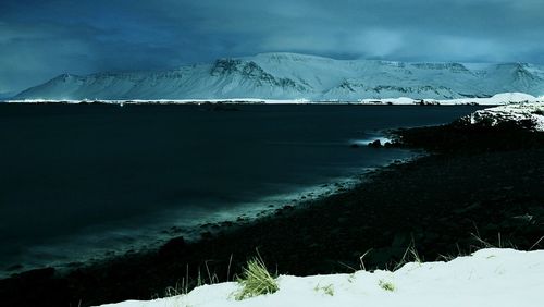 Scenic view of snow covered mountains against sky