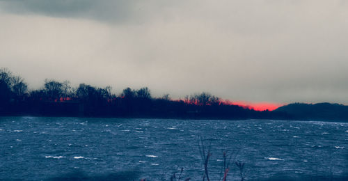 Scenic view of lake at sunset