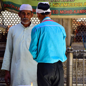 Rear view of a man standing in a city