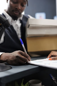 Midsection of man working in office