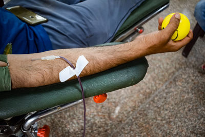 Blood donor at blood donation camp held with a bouncy ball holding in hand at balaji temple