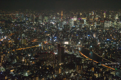 High angle view of illuminated buildings in city at night