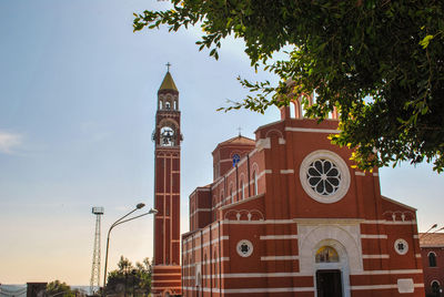 Low angle view of clock tower against sky