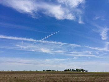 Scenic view of field against cloudy sky