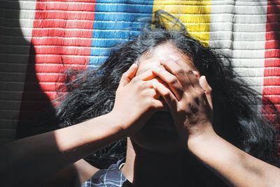 Portrait of woman covering face