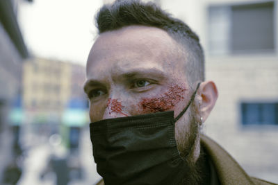 Close-up portrait of man in snow