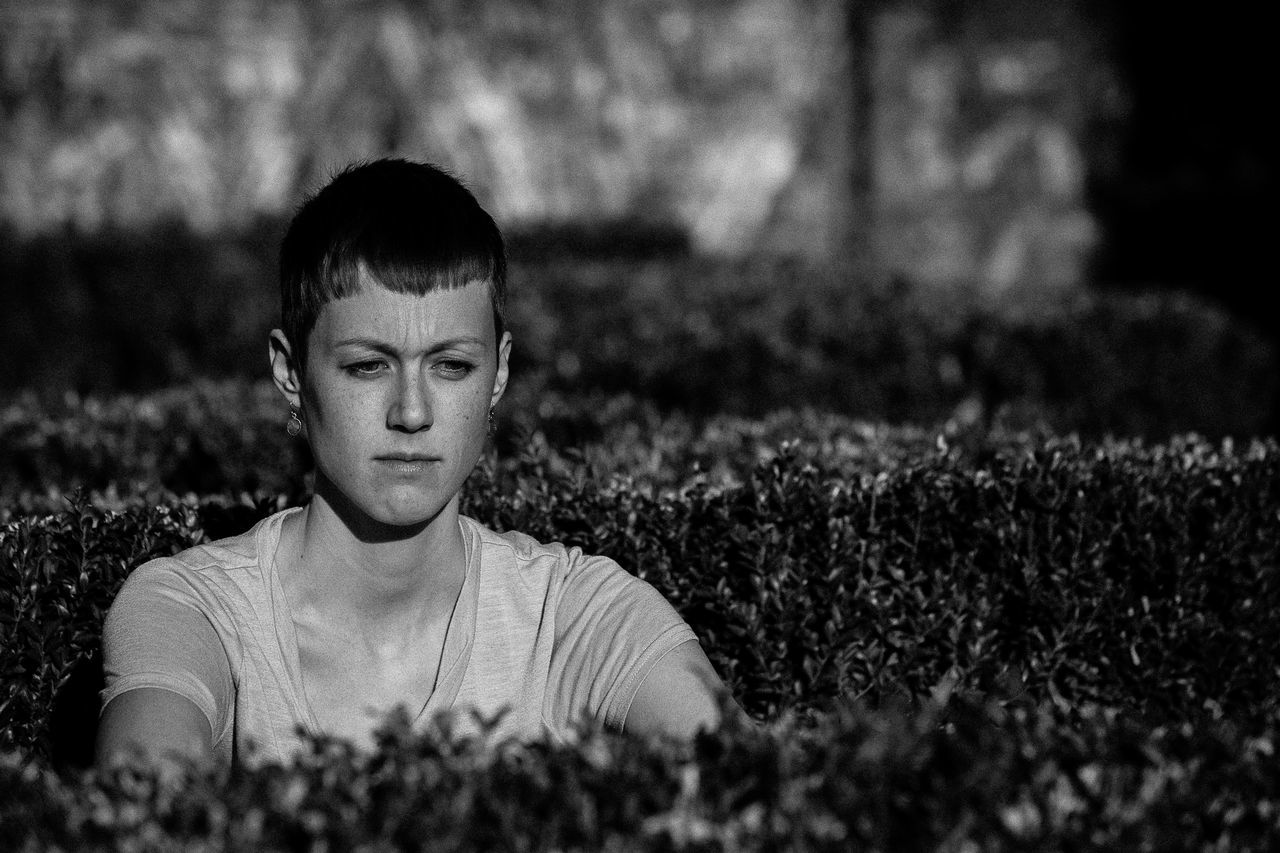 portrait, looking at camera, one person, plant, front view, real people, nature, lifestyles, growth, field, leisure activity, land, child, boys, childhood, headshot, selective focus, men, males, outdoors, teenager, innocence