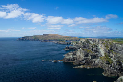 Scenic view of sea and mountains against sky