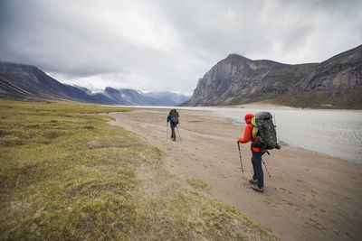 Rear view of backpackers traversing akshayak pass