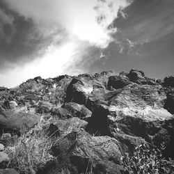 Rock formation on landscape against sky