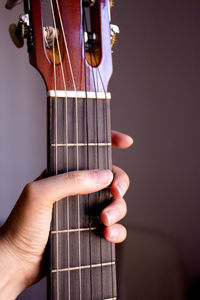 Close-up of hand holding guitar