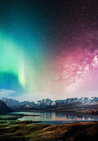 Scenic view of snowcapped mountains against sky at night