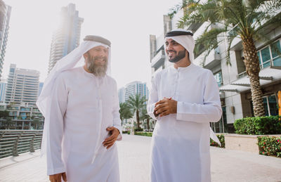 Business people discussing while standing in city