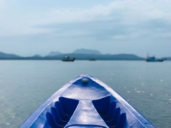 Close-up of boat in sea against sky