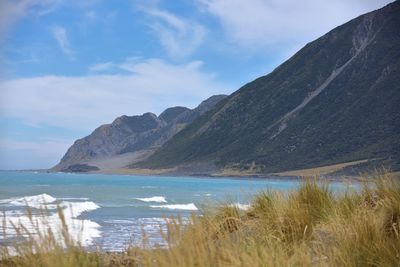 Scenic view of lake and mountains against sky