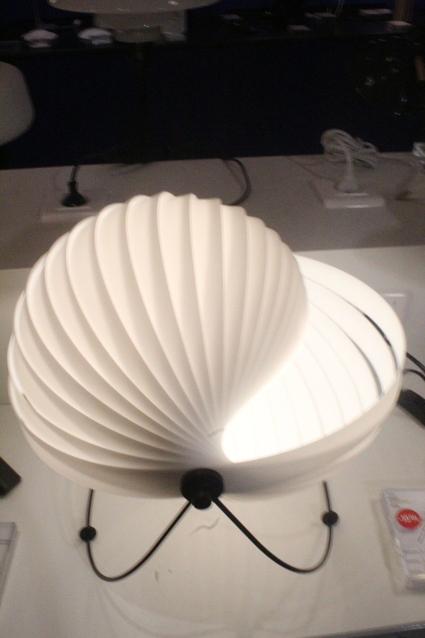 LOW ANGLE VIEW OF ILLUMINATED LIGHT BULB ON TABLE