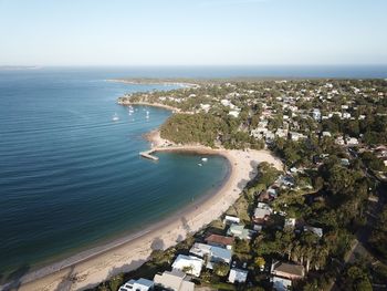 High angle view of townscape by sea against sky