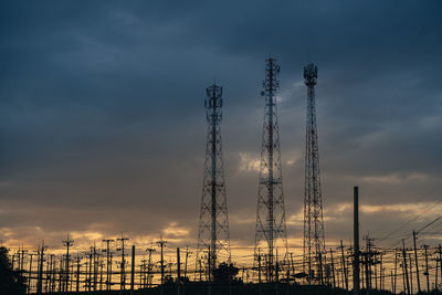 Silhouette electricity pylon against sky during sunset