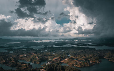 Aerial view of sea and mountains against sky