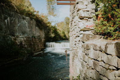 Close-up of stone wall by river