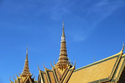 Low angle view of temple building against blue sky