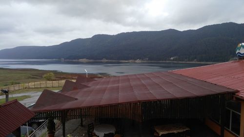 Scenic view of building by mountains against sky
