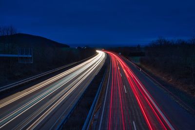 High angle view of light trails on highway at night