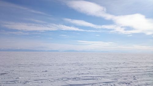 Scenic view of frozen landscape against sky