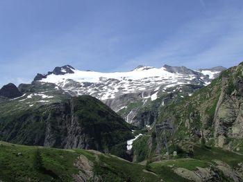 Rocky mossed mountain range against blue sky