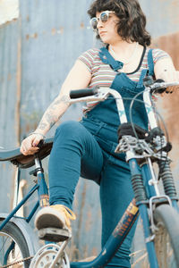 Low angle portrait of woman about to ride bicycle