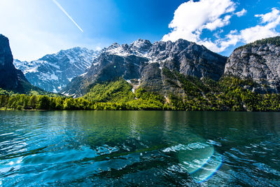 Scenic view of lake and mountains against sky