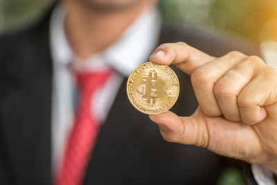 Close-up of hand holding coins