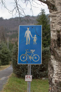 Close-up of road sign against trees