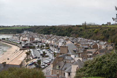 High angle view of houses in town against sky