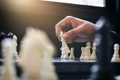 Cropped hand of man playing on chess