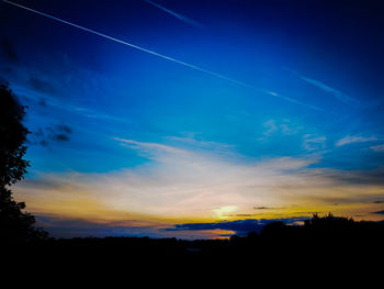 Silhouette landscape against sky at sunset