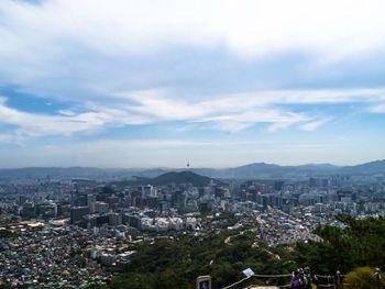 Cityscape against cloudy sky