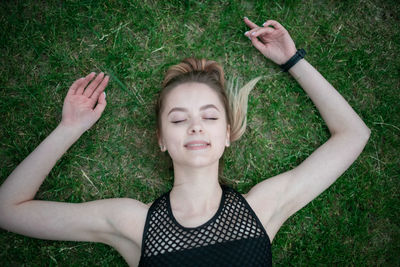 High angle view of woman lying on grass