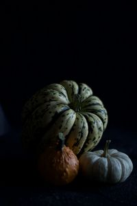 Close-up of fruits on table against black background
