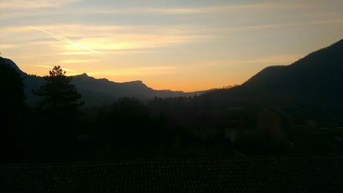 Scenic view of mountains against sky at sunset