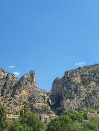 Scenic view of rocky mountains against clear blue sky