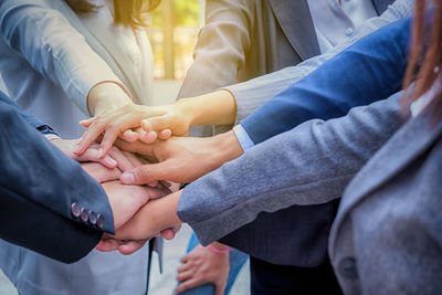 Midsection of couple holding hands