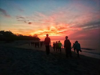 Silhouette of people at sunset