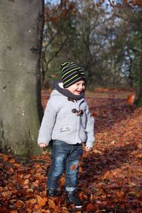 Smiling boy standing on field at park