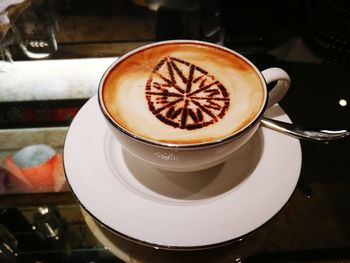 Close-up of cappuccino served on table