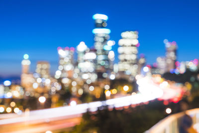 Defocused image of illuminated city buildings at night