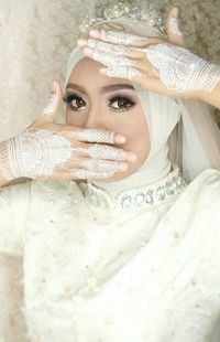 Portrait of bride showing henna tattoo