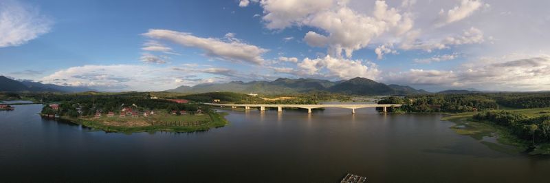 Scenic view of river and mountains against sky