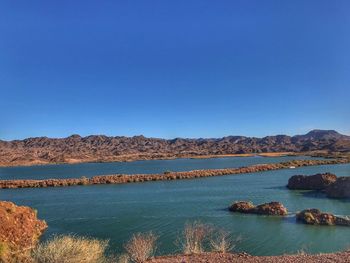 Scenic view of mountains against clear blue sky